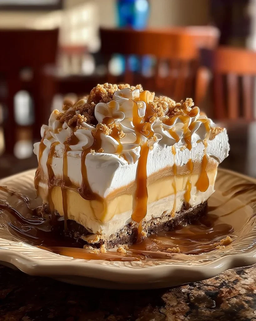 Amish peanut butter cream pie topped with whipped cream and crushed peanuts