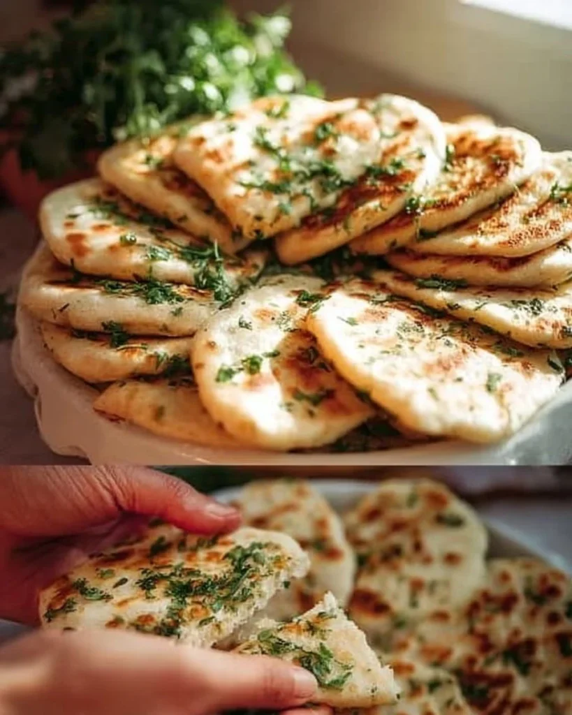 Homemade best pan flatbread on a wooden table with fresh herbs.