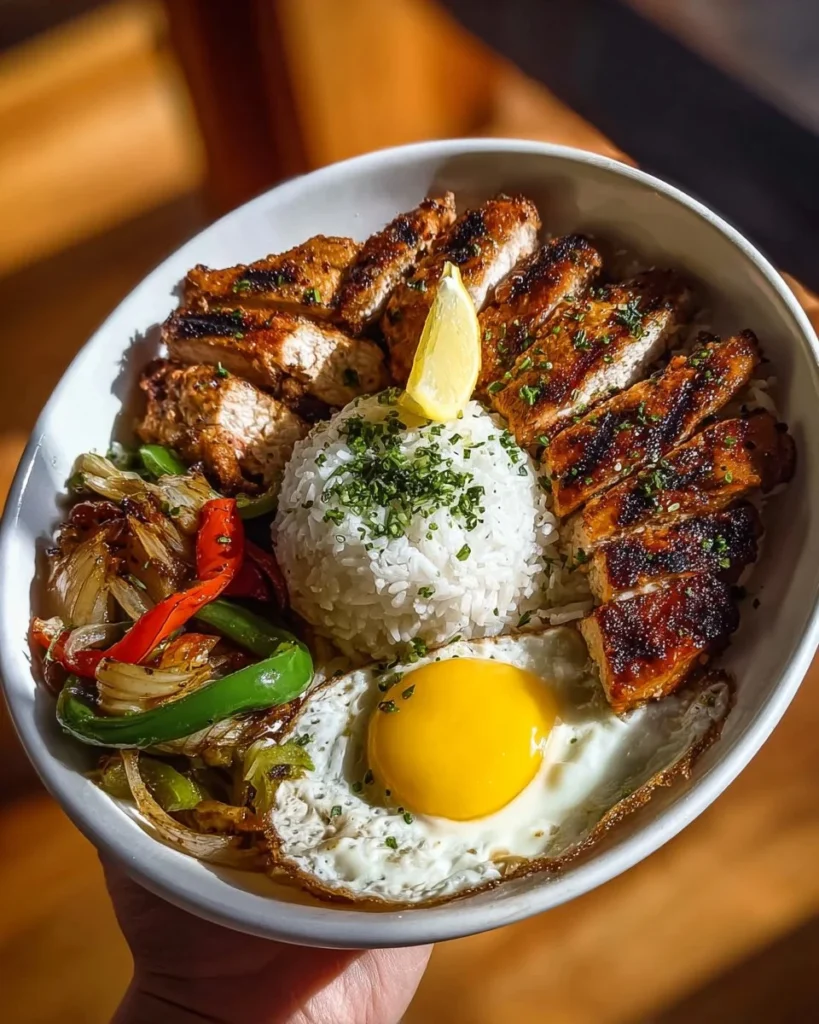 Charred chicken served with rice in a nutritious power plate.