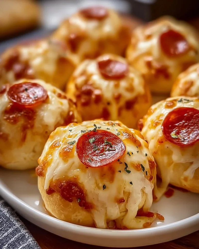 Cheesy Pepperoni Pizza Bombs served on a wooden board