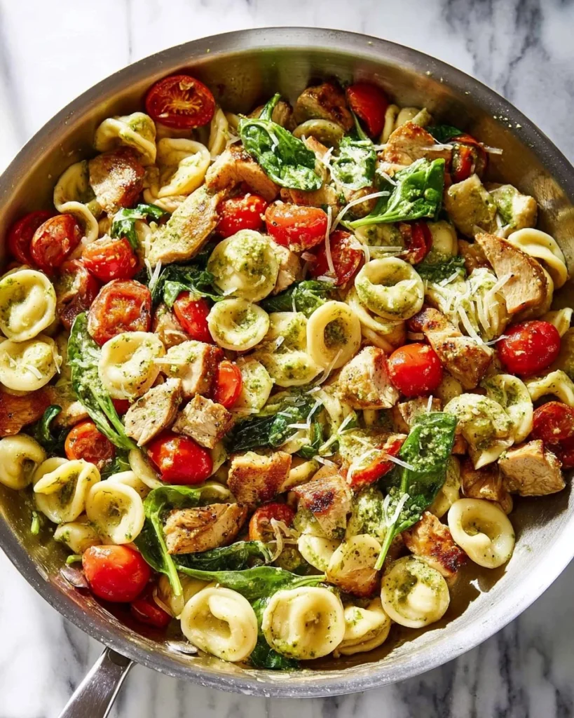 Delicious chicken pesto pasta served in a bowl with fresh basil and Parmesan cheese