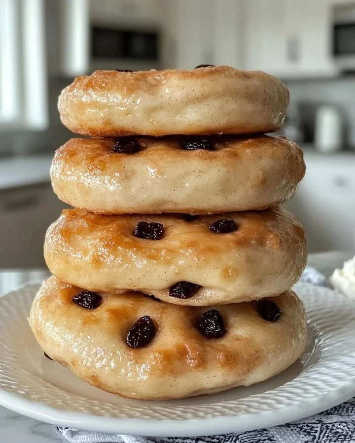 Freshly baked cinnamon raisin bagels on a wooden table