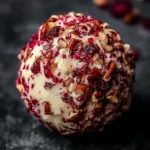 Cranberry Pecan Cheese Ball garnished with nuts and cranberries