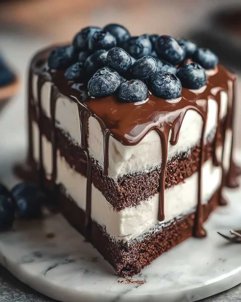 Slice of creamy luxurious chocolate cake with rich frosting and decorations