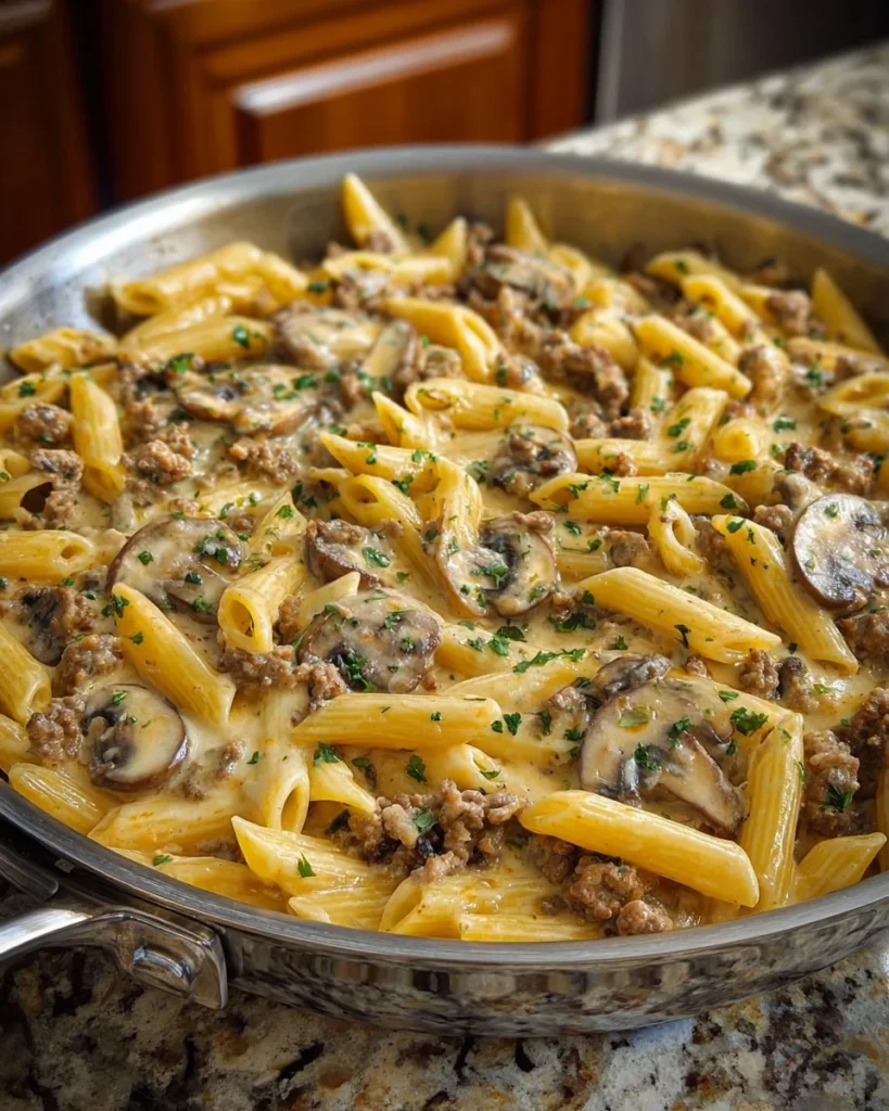 Creamy Velveeta beef stroganoff served over penne pasta in a bowl