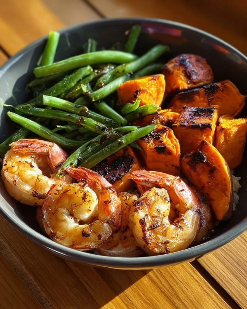 Garlic shrimp dish with Japanese sweet potato and green beans on a plate