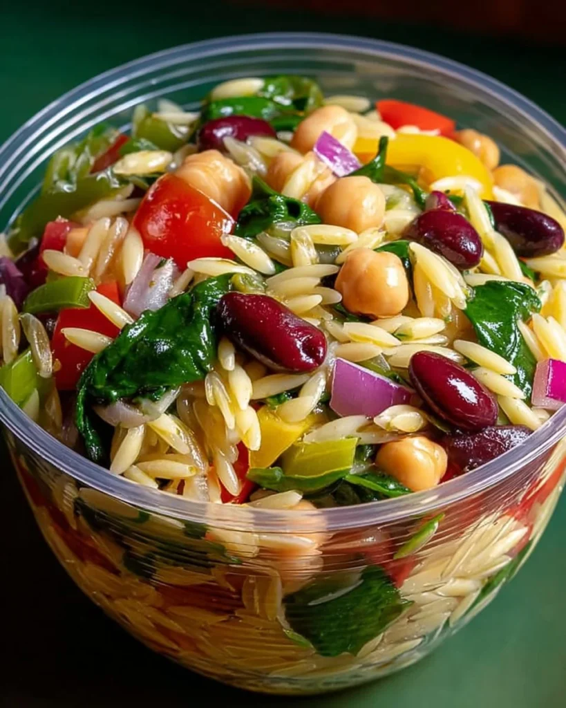 Delicious Greek Orzo Salad with colorful vegetables and feta cheese