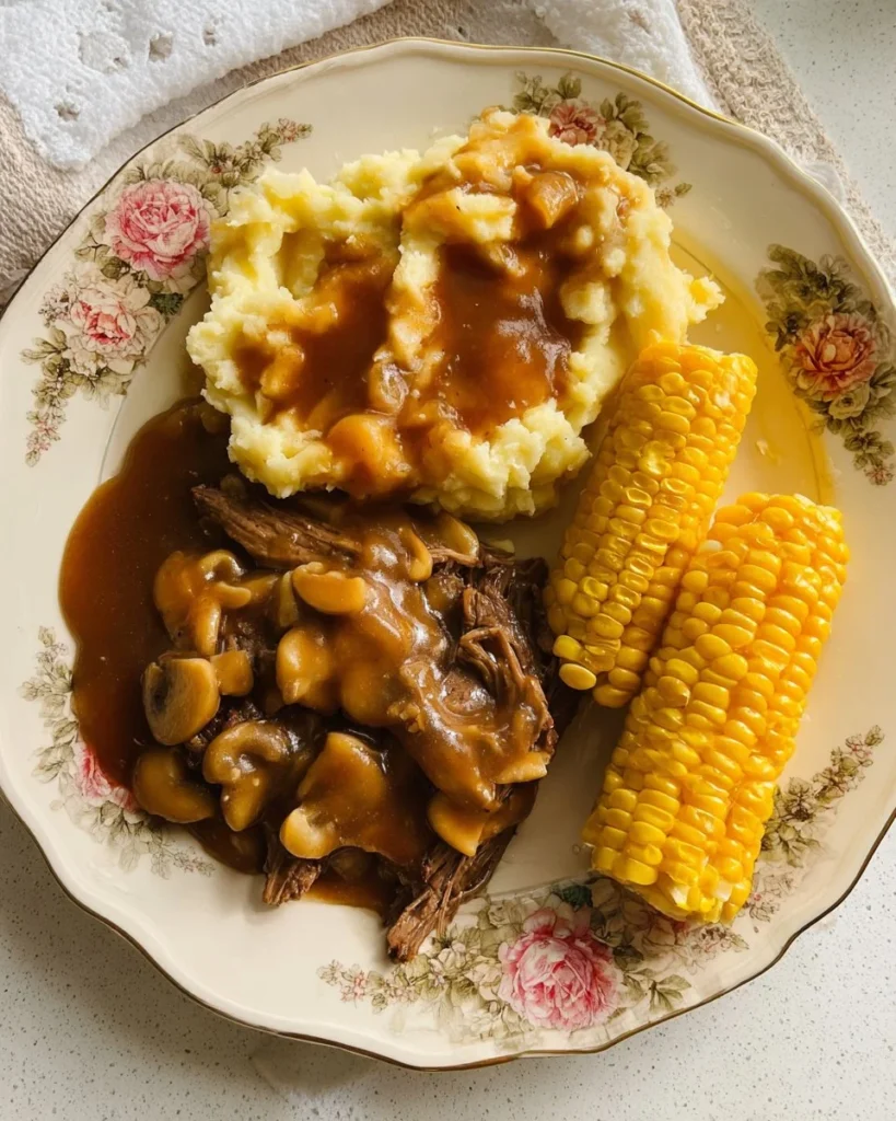 Delicious hamburger steak with creamy mashed potatoes and corn on a plate