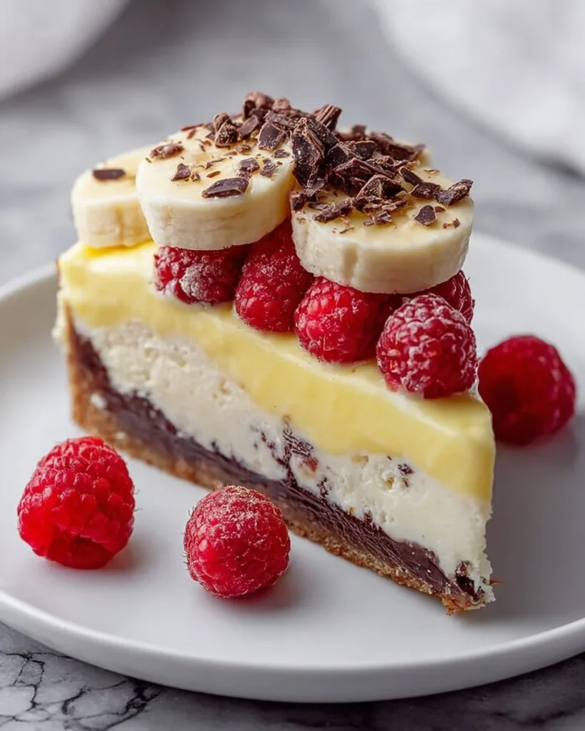 No-bake banana split cheesecake topped with whipped cream and cherries