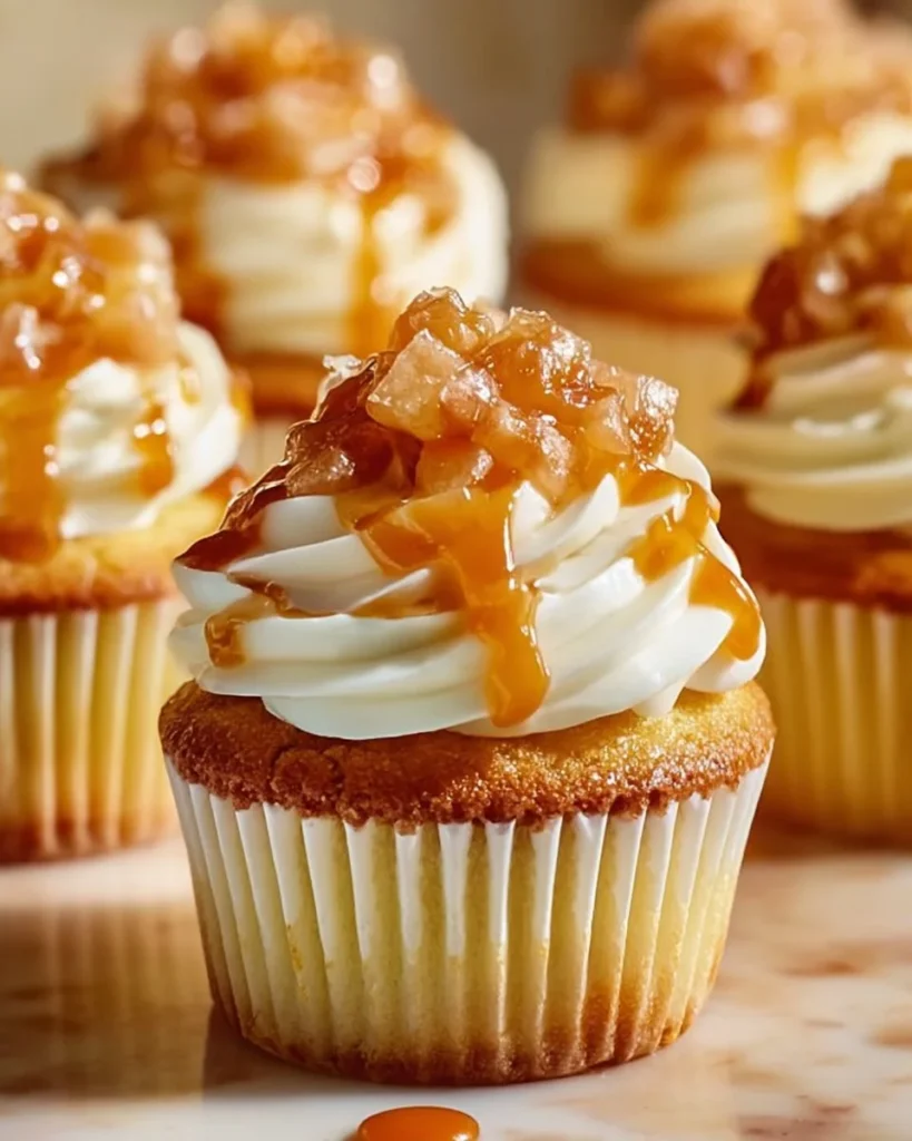 Honey Peach Cream Cheese Cupcakes topped with fresh peach slices and cream frosting