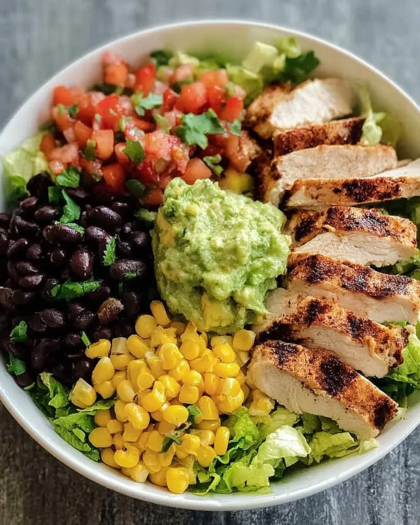 Loaded Southwest Chicken Bowl with Guacamole and Beans ready to serve