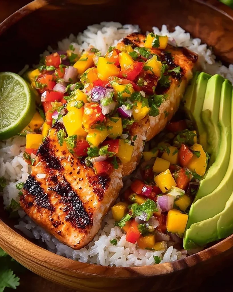 Mediterranean grilled salmon with mango salsa and rice on a plate