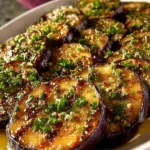 Mediterranean Lemon Garlic Roasted Eggplant dish garnished with herbs
