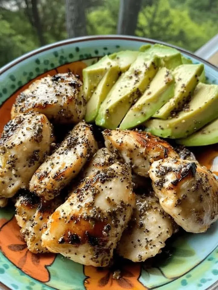 Mediterranean lemon pepper chicken garnished with fresh avocado slices.