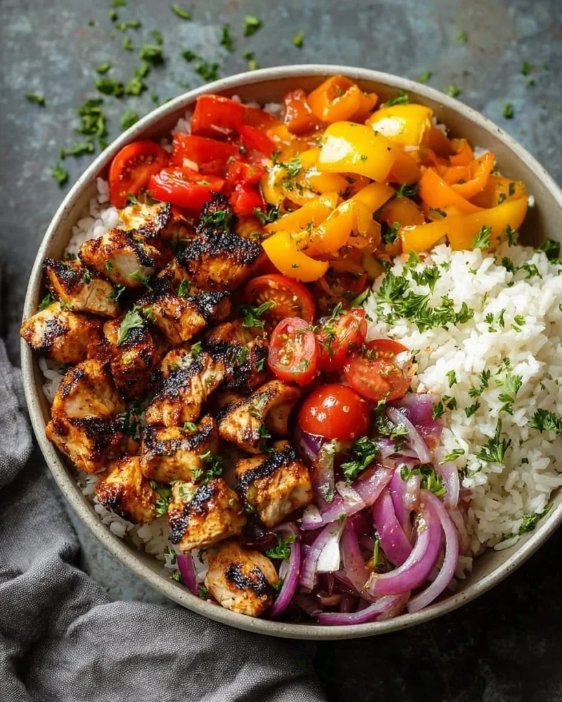 Colorful Mediterranean rice bowl with fresh vegetables and herbs.