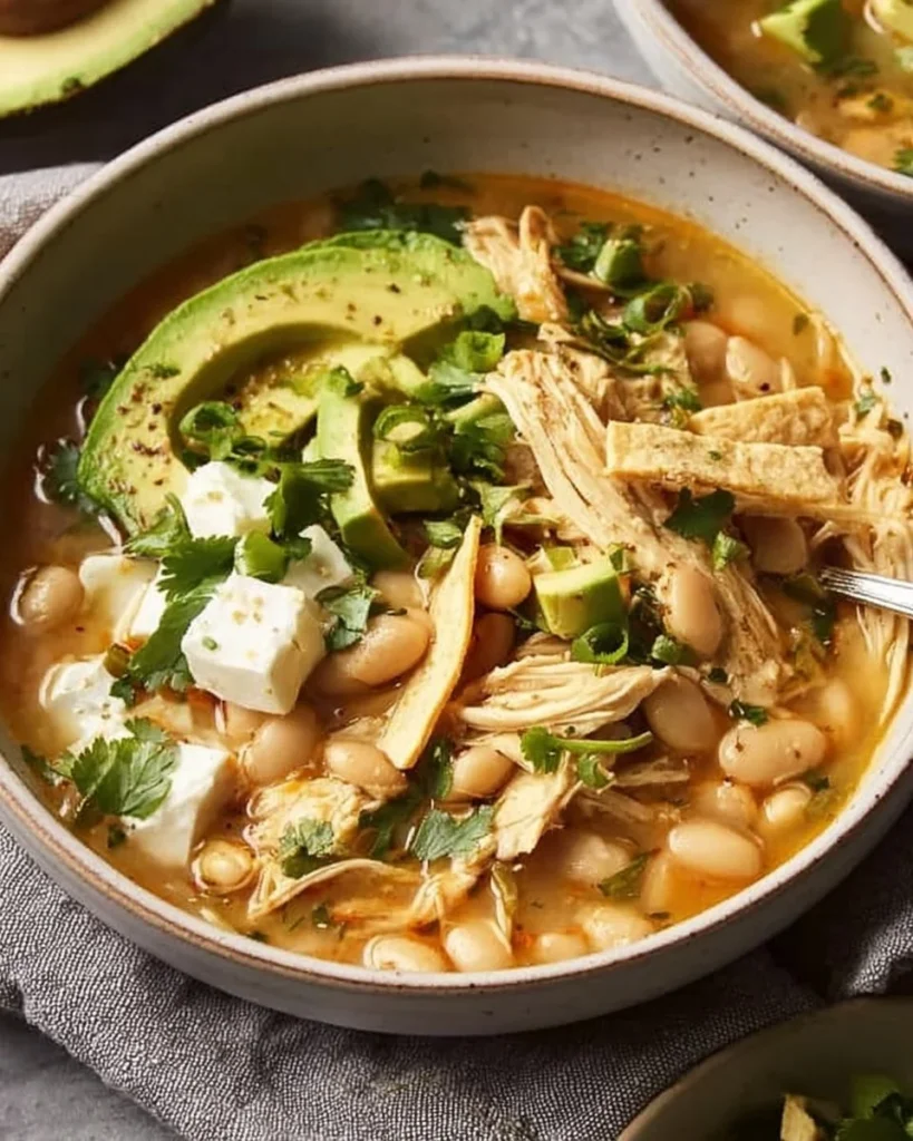 Bowl of Mediterranean White Chicken Chili with fresh herbs and toppings
