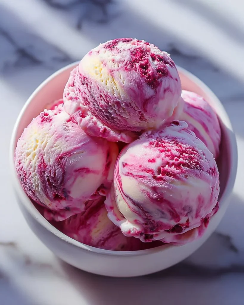 Delicious homemade raspberry swirl ice cream in a bowl.