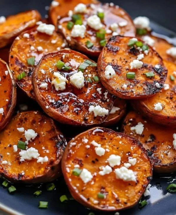 Plate of roasted sweet potato rounds with honey drizzle and feta cheese