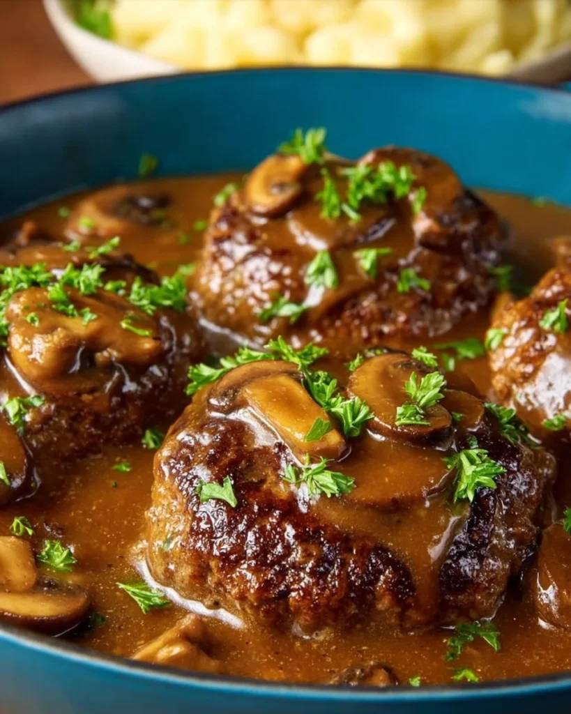 Salisbury steak topped with rich mushroom gravy on a plate