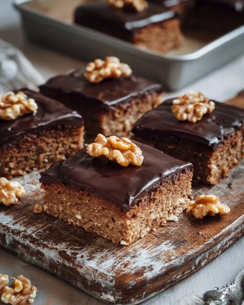 Delicious Sheet Pan Walnut Cake topped with walnuts and served on a plate.