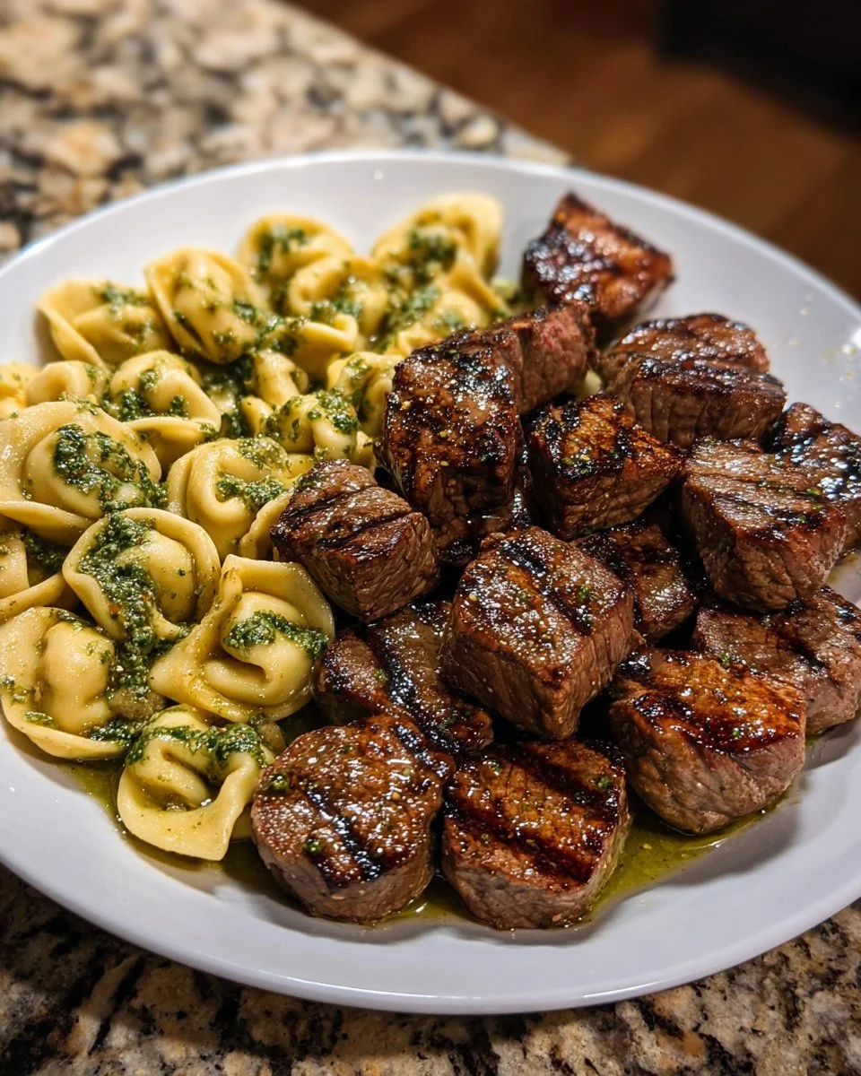 Tender steak bites served with pesto Alfredo tortellini sauce