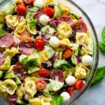 Colorful tortellini salad with fresh vegetables and dressing
