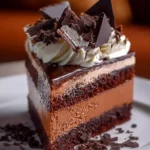 Delicious Triple Chocolate Cheesecake topped with chocolate shavings and sauce.