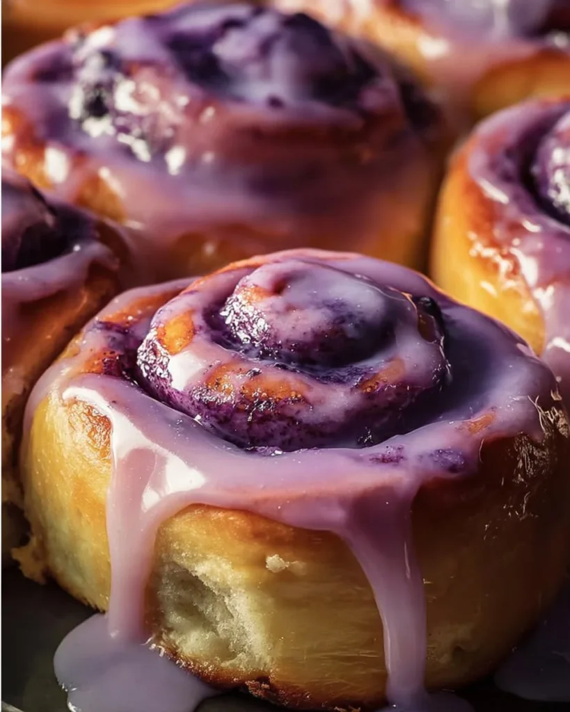 Delicious ube cinnamon rolls with vibrant purple hue and creamy icing