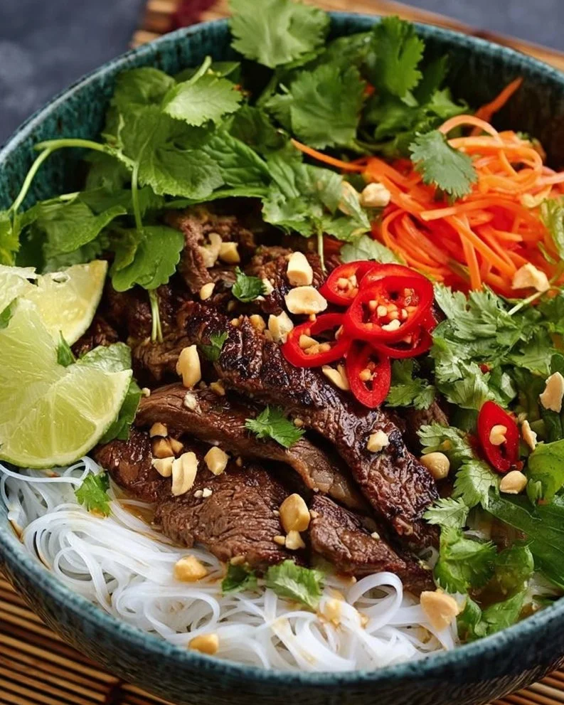 Vietnamese lemongrass beef served with noodles and fresh herbs