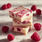 Delicious white chocolate raspberry cheesecake bars displayed on a platter.